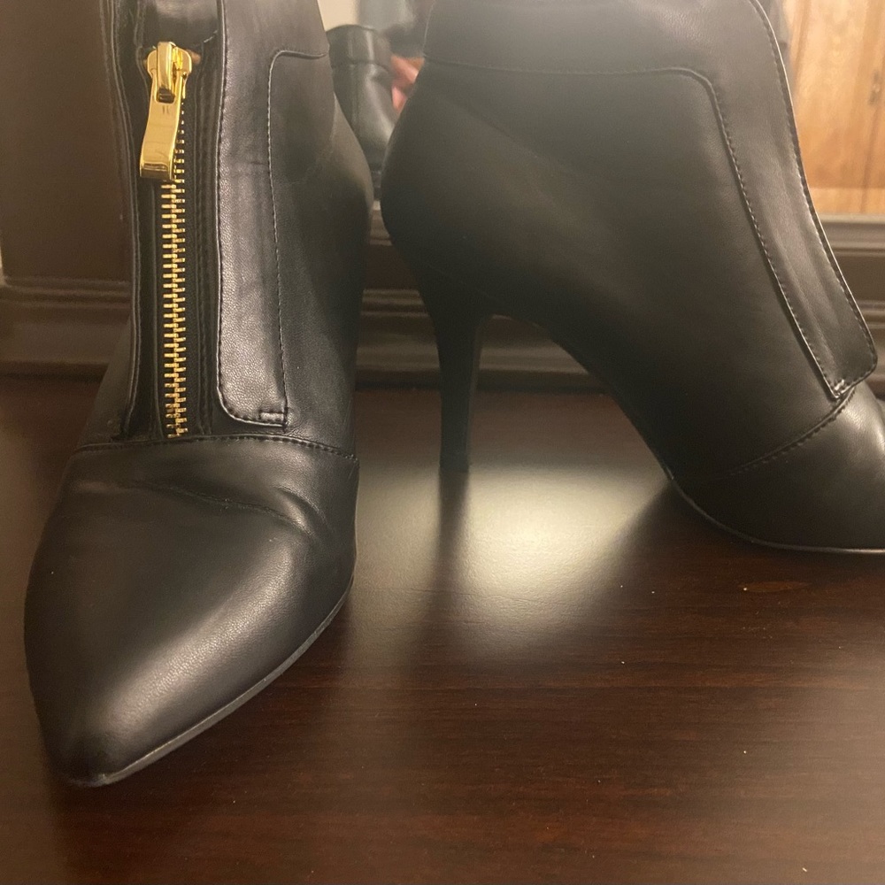 Black heels with gold zipper